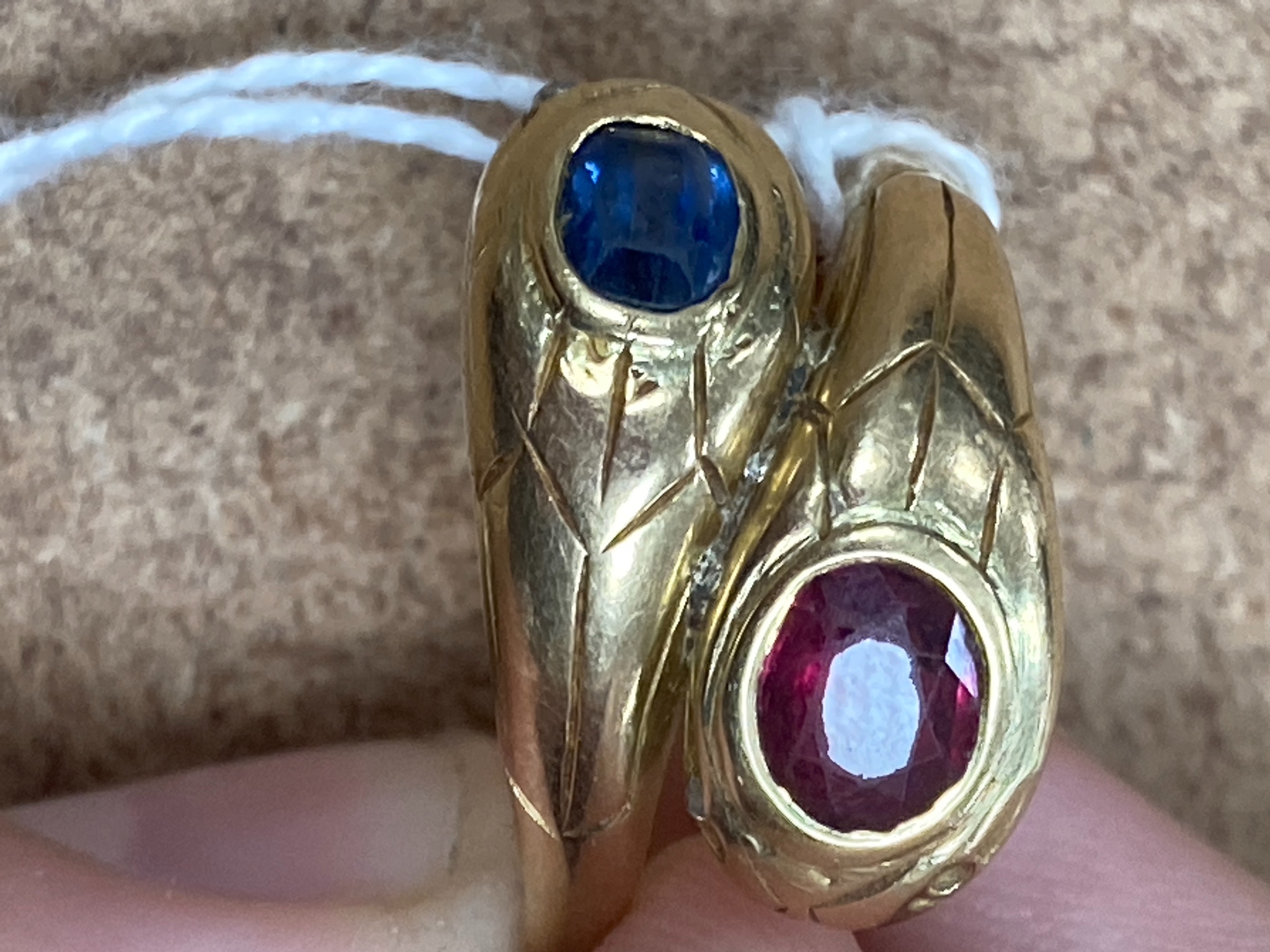 An 18ct yellow gold double 'cobra' ring, sapphire and ruby set, size Q/R, gross 7.6 grams.